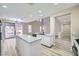 Bright open kitchen features a large island and stainless appliances with a view of the backyard at 9272 W Viking Rd, Las Vegas, NV 89147