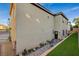 Backyard with paving stone patio, wrought iron fencing, and garden and synthetic grass at 9715 Aleutian St, Las Vegas, NV 89178