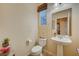 Cozy powder room featuring a pedestal sink, toilet, and neutral wall color at 9715 Aleutian St, Las Vegas, NV 89178