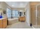 Bright bathroom featuring a shower, bathtub, and double vanity sinks at 9715 Aleutian St, Las Vegas, NV 89178