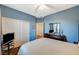 Bedroom offers a queen bed, hardwood floors, blue walls, closet, and natural lighting at 9715 Aleutian St, Las Vegas, NV 89178