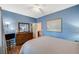 Well-lit bedroom featuring hardwood floors, blue walls, and neutral accents throughout at 9715 Aleutian St, Las Vegas, NV 89178