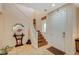 Inviting entryway featuring a staircase, decorative mirror, and neutral tones for a warm welcome at 9715 Aleutian St, Las Vegas, NV 89178