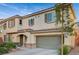Two-story home with a tile roof, a two-car garage, and mature landscaping in front at 9715 Aleutian St, Las Vegas, NV 89178
