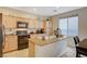 Bright kitchen featuring granite countertops, a kitchen island, and modern appliances at 9715 Aleutian St, Las Vegas, NV 89178
