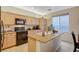 Bright kitchen featuring granite countertops, a kitchen island, and modern appliances at 9715 Aleutian St, Las Vegas, NV 89178