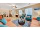 Bright and spacious living room featuring tile floors, plush seating, and a staircase in background at 9715 Aleutian St, Las Vegas, NV 89178