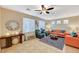 Cozy living room with a ceiling fan, plush seating, and a decorative rug at 9715 Aleutian St, Las Vegas, NV 89178