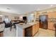Bright open floor plan with kitchen island, dining table, and relaxed living room at 9715 Aleutian St, Las Vegas, NV 89178