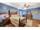 Bedroom with traditional-style furniture, hardwood floors, and a ceiling fan at 9715 Aleutian St, Las Vegas, NV 89178