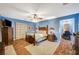 Bedroom features hardwood floors, a ceiling fan, and an attached sitting room at 9715 Aleutian St, Las Vegas, NV 89178