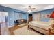 Primary bedroom featuring hardwood floors and a sitting area with comfortable futon at 9715 Aleutian St, Las Vegas, NV 89178