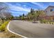 Street view of a neighborhood with trees and well maintained landscaping under a bright sunny sky at 9715 Aleutian St, Las Vegas, NV 89178