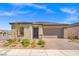 Inviting single-story home with a brick driveway, desert landscaping, and neutral color palette at 10186 Zeta Tucana St, Las Vegas, NV 89143