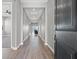 Open hallway with wood floors, neutral walls, and views to the mountains from the living room at 10186 Zeta Tucana St, Las Vegas, NV 89143