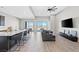 Spacious living room featuring wood floors, modern decor, and mountain views through sliding glass doors at 10186 Zeta Tucana St, Las Vegas, NV 89143