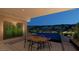Elegant outdoor dining area with a pool view and manicured landscaping at 120 Still Shores St, Henderson, NV 89011