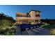 A modern home's backyard featuring a sleek pool, lounge chairs, and well-manicured landscaping at 120 Still Shores St, Henderson, NV 89011