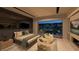A stylish bedroom with a king-sized bed and a beautiful outdoor view and fireplace at 120 Still Shores St, Henderson, NV 89011