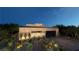 Stunning modern home with desert landscaping and a two-car garage at twilight at 120 Still Shores St, Henderson, NV 89011
