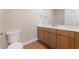 Well-lit bathroom with modern vanity, light countertops, contemporary toilet, and wood-look flooring at 128 Los Cabos Dr # 202, Las Vegas, NV 89144