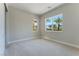 Bright bedroom with plush carpet, light walls, and views of palm trees at 128 Los Cabos Dr # 202, Las Vegas, NV 89144