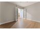 Neutral bedroom showcasing an open doorway, light hardwood floors, and natural light at 128 Los Cabos Dr # 202, Las Vegas, NV 89144
