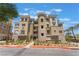 Stunning condo building showcasing modern architecture, a meticulously landscaped entrance, and picturesque palm trees at 128 Los Cabos Dr # 202, Las Vegas, NV 89144