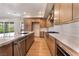 Modern kitchen featuring an island with stainless steel sink, quartz countertops, and stainless appliances at 128 Los Cabos Dr # 202, Las Vegas, NV 89144