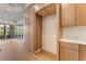 Pantry with light wood cabinets and quartz countertop with a sliding glass door to the outside balcony at 128 Los Cabos Dr # 202, Las Vegas, NV 89144