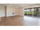 Bright living room with hardwood floors, fireplace and expansive sliding doors leading to a balcony at 128 Los Cabos Dr # 202, Las Vegas, NV 89144