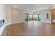Bright, open living room featuring a modern fireplace, hardwood floors, and access to an outdoor balcony with a view at 128 Los Cabos Dr # 202, Las Vegas, NV 89144