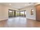 Bright living room featuring hardwood floors and large sliding glass doors that open to a scenic balcony at 128 Los Cabos Dr # 202, Las Vegas, NV 89144