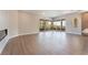 Spacious living room with hardwood floors, a sleek fireplace, and access to a large patio with a view at 128 Los Cabos Dr # 202, Las Vegas, NV 89144