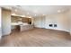 Open concept space featuring a modern kitchen with hardwood floors and a fireplace at 128 Los Cabos Dr # 202, Las Vegas, NV 89144