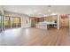 Open concept living room and kitchen area with hardwood floors and sliding glass doors leading to balcony at 128 Los Cabos Dr # 202, Las Vegas, NV 89144