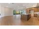 Open-concept living space featuring a modern kitchen island with adjacent fireplace and large sliding glass door to balcony at 128 Los Cabos Dr # 202, Las Vegas, NV 89144