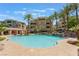 Community pool with lounge chairs and palm trees, a perfect place to relax at 128 Los Cabos Dr # 202, Las Vegas, NV 89144