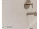 Close up on a modern shower faucet and shower head with white subway tiling at 128 Los Cabos Dr # 202, Las Vegas, NV 89144