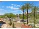 Eye-level landscaped neighborhood view with tall palm trees and buildings at 128 Los Cabos Dr # 202, Las Vegas, NV 89144