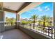 A covered balcony with views of palm trees and building at 128 Los Cabos Dr # 302, Las Vegas, NV 89144