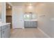 Bathroom featuring gray cabinets, tile flooring and a closet entrance at 128 Los Cabos Dr # 302, Las Vegas, NV 89144