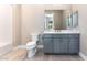 Bathroom features a gray vanity with a white countertop, toilet, and a mirror at 128 Los Cabos Dr # 302, Las Vegas, NV 89144