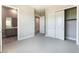 View of a bedroom featuring gray walls, carpeted floor, closet, and an entrance to the bathroom at 128 Los Cabos Dr # 302, Las Vegas, NV 89144