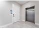 Modern hallway with sleek elevator and white entrance door, adding convenience and style to the space at 128 Los Cabos Dr # 302, Las Vegas, NV 89144