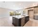 Open-concept floor plan featuring a kitchen island, stainless steel dishwasher and lots of natural light at 128 Los Cabos Dr # 302, Las Vegas, NV 89144