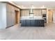 Open-concept kitchen with a central island, modern appliances, and ample cabinet space at 128 Los Cabos Dr # 302, Las Vegas, NV 89144