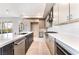 Modern kitchen features a large island, stainless steel appliances and sleek white countertops at 128 Los Cabos Dr # 302, Las Vegas, NV 89144