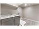 Bright laundry room featuring a sink, sleek gray cabinets, and a washing machine hookup at 128 Los Cabos Dr # 302, Las Vegas, NV 89144