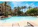 Beautiful resort-style pool with lush landscaping and lounge chairs at 128 Los Cabos Dr # 302, Las Vegas, NV 89144